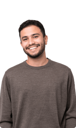 Smiling young man in a brown sweater